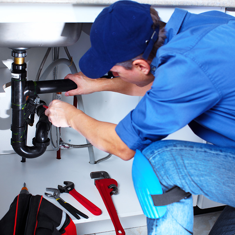 Worker Fixing Sink Leak